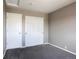 Bedroom features sliding closet doors, neutral paint, plush carpeting, and a ceiling light at 245 Homestead Way, Brighton, CO 80601
