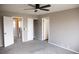 Spacious bedroom with neutral paint, plush carpet, ceiling fan, and a closet at 245 Homestead Way, Brighton, CO 80601