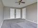 Bedroom with gray carpet, ceiling fan, and closet at 245 Homestead Way, Brighton, CO 80601