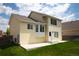 Two-story home showcasing a well-maintained lawn, concrete patio, and a light yellow color scheme at 245 Homestead Way, Brighton, CO 80601