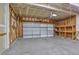 Spacious garage with a concrete floor, work bench, storage, and an insulated garage door at 245 Homestead Way, Brighton, CO 80601