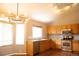 Bright kitchen featuring stainless steel appliances, modern light fixtures, and wood cabinets at 245 Homestead Way, Brighton, CO 80601