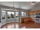 Bright kitchen with stainless steel appliances, light wood cabinetry, and a dining area with large windows at 245 Homestead Way, Brighton, CO 80601