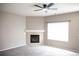 Cozy living room featuring a gas fireplace, large window, and neutral paint at 245 Homestead Way, Brighton, CO 80601