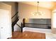 Open living area with hardwood floors, modern lighting, and staircase to the second floor at 245 Homestead Way, Brighton, CO 80601