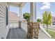 Cozy porch with stone columns and wood flooring, offering a relaxing outdoor space with neighborhood views at 245 Homestead Way, Brighton, CO 80601