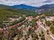 Aerial view showcases property lines, surrounded by trees and mountains at 24 Pine Valley Rd, Evergreen, CO 80439