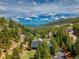 Picturesque aerial view of mountain home surrounded by lush greenery and trees against a backdrop of rolling hills at 24 Pine Valley Rd, Evergreen, CO 80439