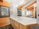 Bathroom with wood plank walls, double vanity, and large mirror offering plenty of light and space at 24 Pine Valley Rd, Evergreen, CO 80439
