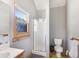 Bathroom with glass door shower, toilet, and a sink next to a window with nice view at 24 Pine Valley Rd, Evergreen, CO 80439