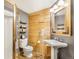 This bathroom features wood accent wall and a shower with glass enclosure and bright natural light at 24 Pine Valley Rd, Evergreen, CO 80439