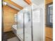 This bathroom features a large glass shower, with wood plank walls and plenty of light at 24 Pine Valley Rd, Evergreen, CO 80439
