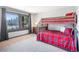 Cozy bedroom featuring a bunk bed with red plaid bedding and a picturesque window view at 24 Pine Valley Rd, Evergreen, CO 80439