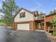 Exterior view of garage with upper deck at 24 Pine Valley Rd, Evergreen, CO 80439
