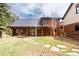 Exterior log home, featuring a stone chimney, and covered porch at 24 Pine Valley Rd, Evergreen, CO 80439