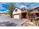 Exterior view of a two-story garage with balcony connected to the main wooden house at 24 Pine Valley Rd, Evergreen, CO 80439