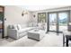 Comfortable living room area with a large grey sectional sofa and sliding glass doors at 24 Pine Valley Rd, Evergreen, CO 80439