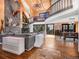 Expansive living room with a large fireplace, spiral staircase, hardwood floors, and floor to ceiling windows at 24 Pine Valley Rd, Evergreen, CO 80439