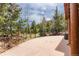 Open patio with metal fence surrounding a forested lot at 24 Pine Valley Rd, Evergreen, CO 80439