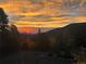 Beautiful sunset view over the mountains and trees at 24 Pine Valley Rd, Evergreen, CO 80439