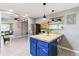 Modern kitchen with island, blue cabinets, stainless steel appliances at 3356 S Julian St, Englewood, CO 80110