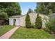 Backyard view featuring a shed with double doors, and lush landscaping surrounding the property at 2432 S Columbine St, Denver, CO 80210