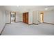 Large basement area with plush carpeting, recessed lighting, and multiple closets for ample storage at 2432 S Columbine St, Denver, CO 80210