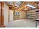 Unfinished basement with exposed wooden beams, concrete flooring, and potential for customization at 2432 S Columbine St, Denver, CO 80210