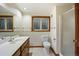 Bathroom featuring a single sink vanity, neutral tiles, and a glass door shower stall at 2432 S Columbine St, Denver, CO 80210