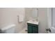 Cozy powder room with a single sink vanity, decorative mirror, and neutral paint at 2432 S Columbine St, Denver, CO 80210
