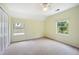 A sunlit room featuring two windows offering beautiful views, neutral-colored walls and plush carpeting at 2432 S Columbine St, Denver, CO 80210
