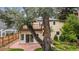 Exterior view of the home's rear facade, balcony, patio, and lush garden at 2432 S Columbine St, Denver, CO 80210