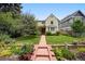 Charming two-story home with landscaped yard and inviting walkway at 2432 S Columbine St, Denver, CO 80210