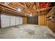 Spacious garage with concrete flooring, white garage door, and exposed wood beam ceiling at 2432 S Columbine St, Denver, CO 80210