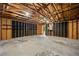 Unfinished garage featuring concrete floor, exposed beams, and installed shelving at 2432 S Columbine St, Denver, CO 80210