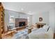 Bright living room with a cozy fireplace, built in shelves, and modern furniture creates a welcoming atmosphere at 2432 S Columbine St, Denver, CO 80210