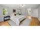 A serene main bedroom boasts hardwood floors, three windows and a plush bed and modern decor at 2432 S Columbine St, Denver, CO 80210