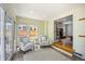 Bright sun room featuring two cozy chairs, a small side table and an entrance to the living room at 2432 S Columbine St, Denver, CO 80210