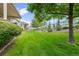 Large backyard with healthy green lawn and mature trees providing ample shade for outdoor enjoyment at 1051 Bramblewood Dr, Castle Pines, CO 80108
