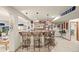 Basement bar with seating, drop lighting, and sports memorabilia displayed throughout the finished living space at 1051 Bramblewood Dr, Castle Pines, CO 80108
