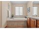 Bathroom features a large soaking tub, tiled surround, and neutral wall color at 1051 Bramblewood Dr, Castle Pines, CO 80108