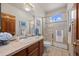 Bathroom with a tiled shower, updated vanity, and stylish fixtures at 1051 Bramblewood Dr, Castle Pines, CO 80108