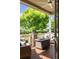 Cozy covered patio with outdoor seating, a ceiling fan, and a view of the lush backyard landscaping at 1051 Bramblewood Dr, Castle Pines, CO 80108