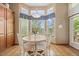 Bright dining area with large windows, wood floors, and a chandelier at 1051 Bramblewood Dr, Castle Pines, CO 80108