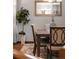 Close-up of dining area including modern light fixture, wood table, and chair details at 1051 Bramblewood Dr, Castle Pines, CO 80108
