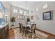 Dining room with wood floors, high ceilings, and a decorative rug at 1051 Bramblewood Dr, Castle Pines, CO 80108