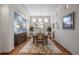 Dining room featuring hardwood floors, a modern light fixture, and light-blue accent wall at 1051 Bramblewood Dr, Castle Pines, CO 80108