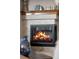 Close up of a modern fireplace with a wood mantle and neutral tiling at 1051 Bramblewood Dr, Castle Pines, CO 80108