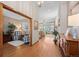 The home's foyer leads to the living spaces featuring hardwood flooring and neutral walls at 1051 Bramblewood Dr, Castle Pines, CO 80108