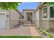 Inviting home entrance featuring a stone facade, seating, and meticulous landscaping at 1051 Bramblewood Dr, Castle Pines, CO 80108
